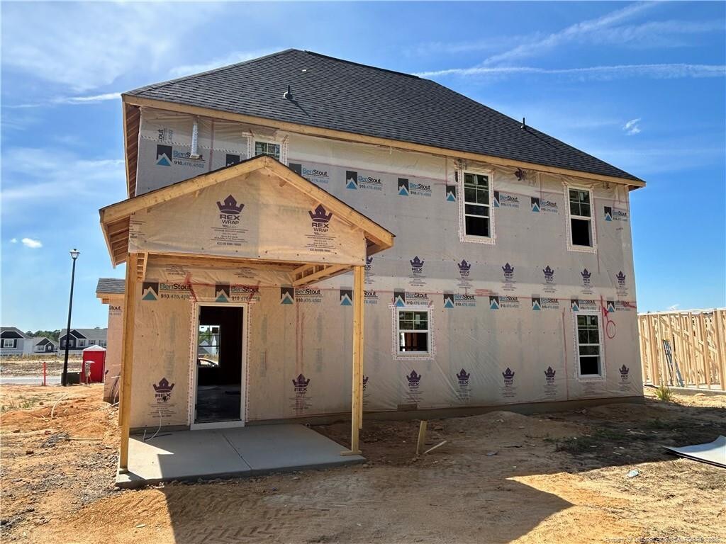 794 Union St, Raeford, NC 28376 - back of house featuring roof with shingles, a patio, and fence