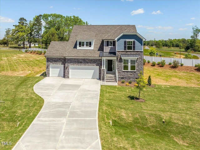 33 Celtic Ln, Lillington, NC 27546 - view of front of house featuring fence, a garage, driveway, stone siding, and a front lawn