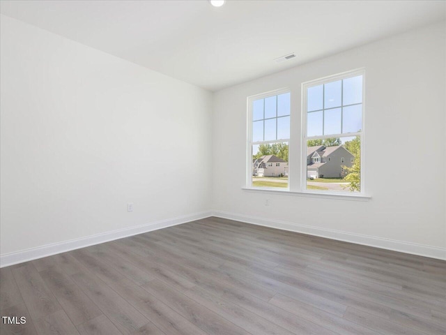 33 Celtic Ln, Lillington, NC 27546 - spare room featuring visible vents, wood finished floors, and baseboards