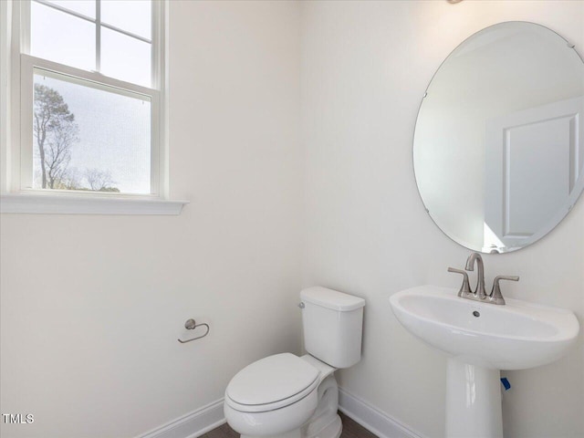 33 Celtic Ln, Lillington, NC 27546 - bathroom with toilet, a sink, and baseboards