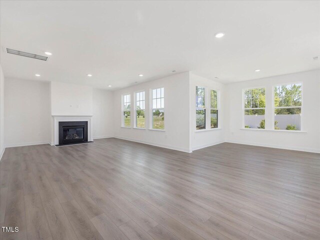 33 Celtic Ln, Lillington, NC 27546 - unfurnished living room with wood finished floors, visible vents, and recessed lighting