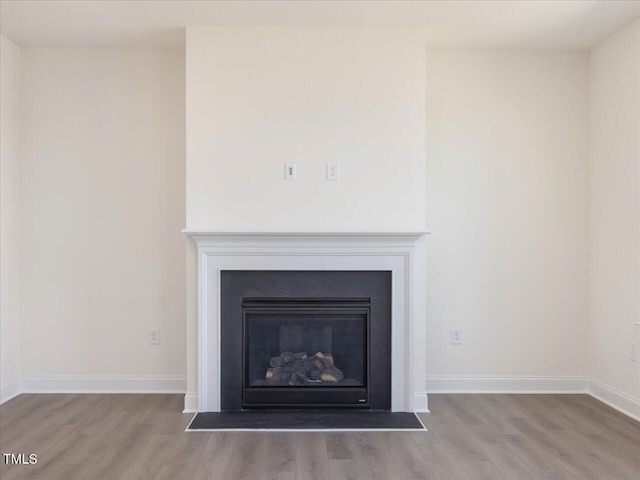 33 Celtic Ln, Lillington, NC 27546 - room details featuring a fireplace with flush hearth, wood finished floors, and baseboards