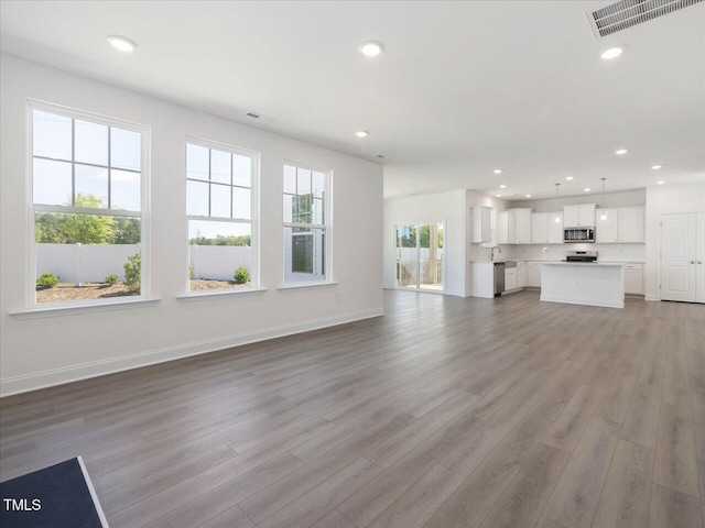 33 Celtic Ln, Lillington, NC 27546 - unfurnished living room featuring visible vents, recessed lighting, light wood finished floors, and baseboards