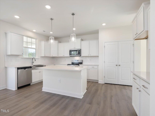 33 Celtic Ln, Lillington, NC 27546 - kitchen featuring a sink, white cabinets, appliances with stainless steel finishes, and decorative backsplash