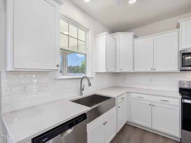 33 Celtic Ln, Lillington, NC 27546 - kitchen with a sink, stainless steel appliances, backsplash, light countertops, and white cabinets