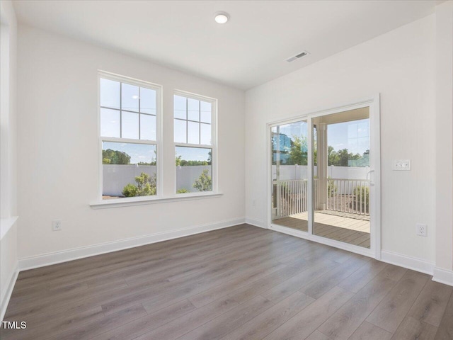 33 Celtic Ln, Lillington, NC 27546 - unfurnished room featuring wood finished floors, visible vents, recessed lighting, and baseboards