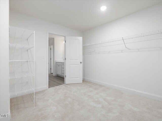 33 Celtic Ln, Lillington, NC 27546 - unfurnished bedroom featuring baseboards, ensuite bath, and carpet flooring