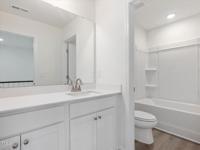 33 Celtic Ln, Lillington, NC 27546 - bathroom featuring toilet, vanity, visible vents, and wood finished floors