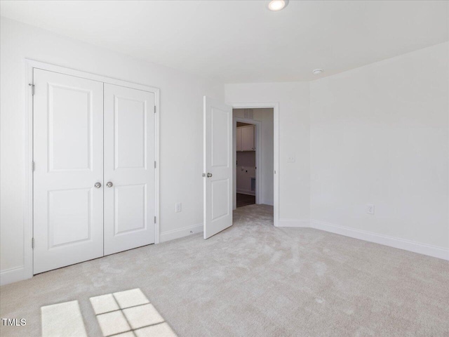 33 Celtic Ln, Lillington, NC 27546 - unfurnished bedroom with light colored carpet, baseboards, recessed lighting, and a closet