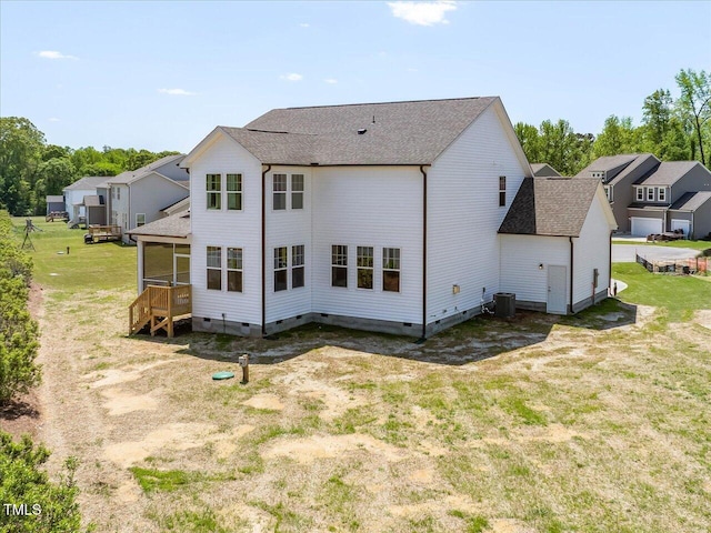 33 Celtic Ln, Lillington, NC 27546 - back of house featuring a sunroom, central air condition unit, crawl space, and roof with shingles