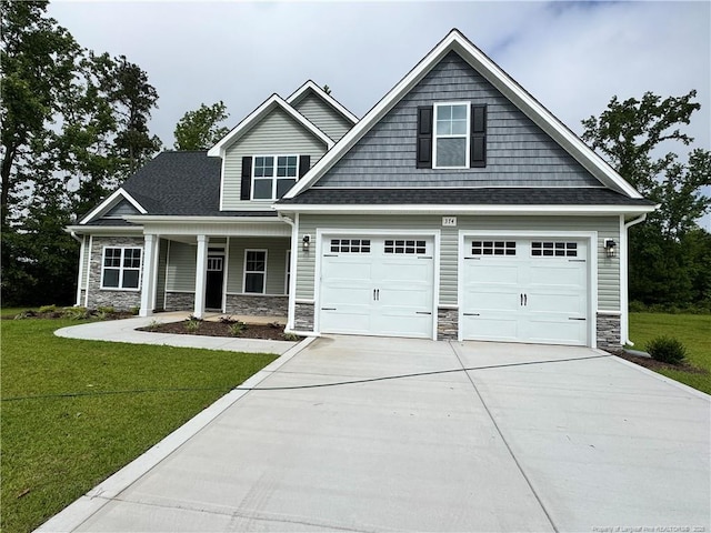 374 Whitestone Dr, Fayetteville, NC 28312 - craftsman-style home with stone siding, driveway, a front lawn, and covered porch