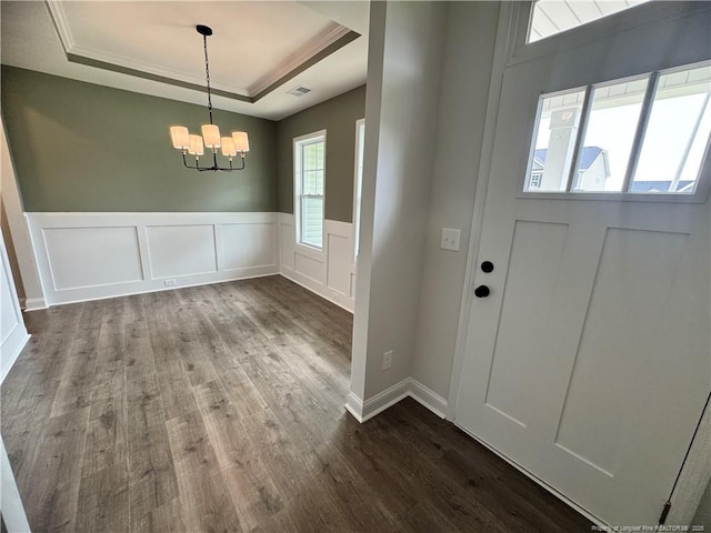 374 Whitestone Dr, Fayetteville, NC 28312 - entryway with a tray ceiling, dark wood-type flooring, a chandelier, a decorative wall, and wainscoting