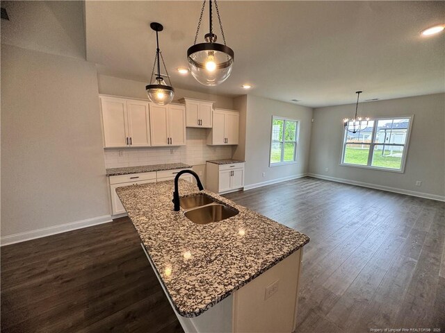 374 Whitestone Dr, Fayetteville, NC 28312 - kitchen featuring a chandelier, stone counters, decorative backsplash, dark wood-style flooring, and recessed lighting