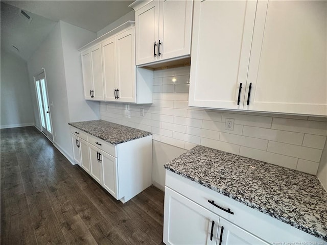 374 Whitestone Dr, Fayetteville, NC 28312 - kitchen with dark stone counters, dark wood-style floors, white cabinets, and tasteful backsplash