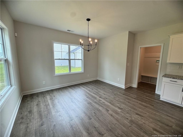 374 Whitestone Dr, Fayetteville, NC 28312 - unfurnished dining area with healthy amount of natural light, a chandelier, and dark wood-style flooring