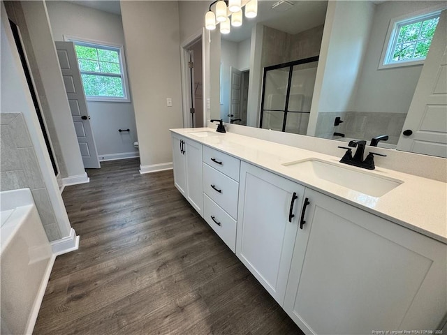374 Whitestone Dr, Fayetteville, NC 28312 - full bathroom with double vanity, a bath, wood finished floors, a shower stall, and a chandelier