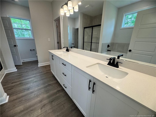 374 Whitestone Dr, Fayetteville, NC 28312 - bathroom with a shower stall, double vanity, wood finished floors, and a chandelier