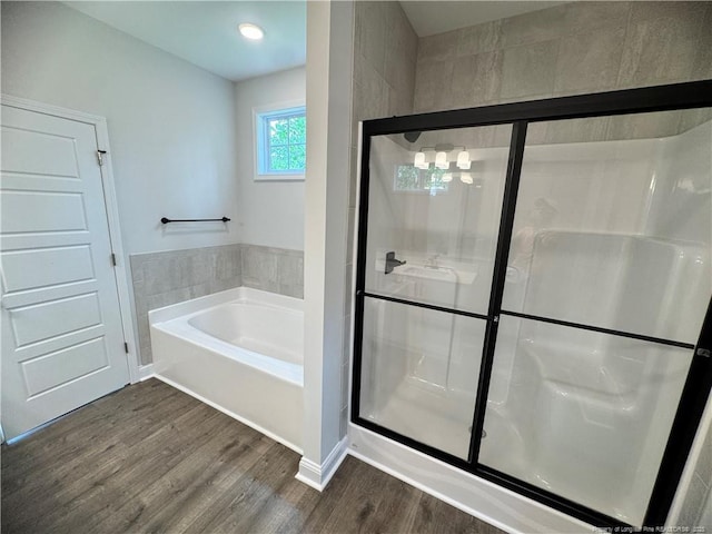 374 Whitestone Dr, Fayetteville, NC 28312 - bathroom with wood finished floors, a bath, and a stall shower