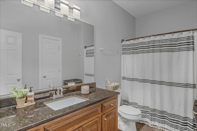 full bath with tile patterned floors, vanity, and toilet