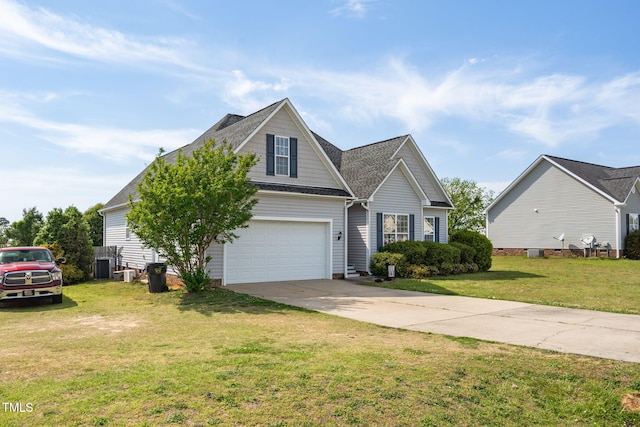 view of front facade with a shingled roof, a garage, driveway, cooling unit, and a front yard