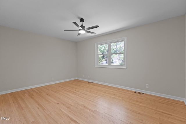 empty room with ceiling fan, visible vents, baseboards, and light wood-style floors
