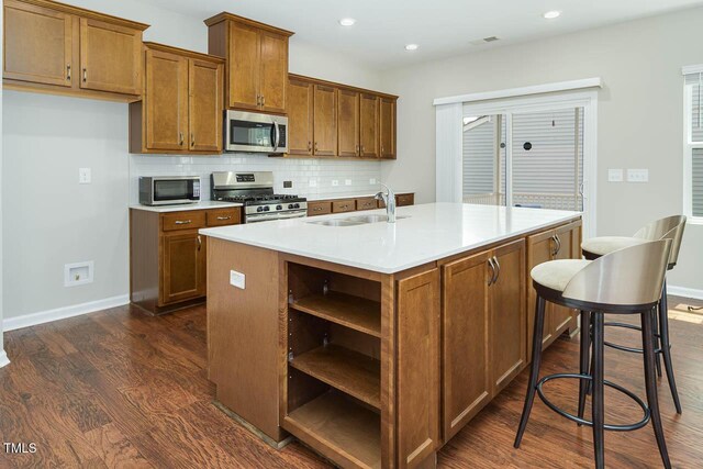 1018 Excite Ave, Morrisville, NC 27560 - kitchen featuring stainless steel appliances, open shelves, dark wood-style floors, brown cabinets, and recessed lighting