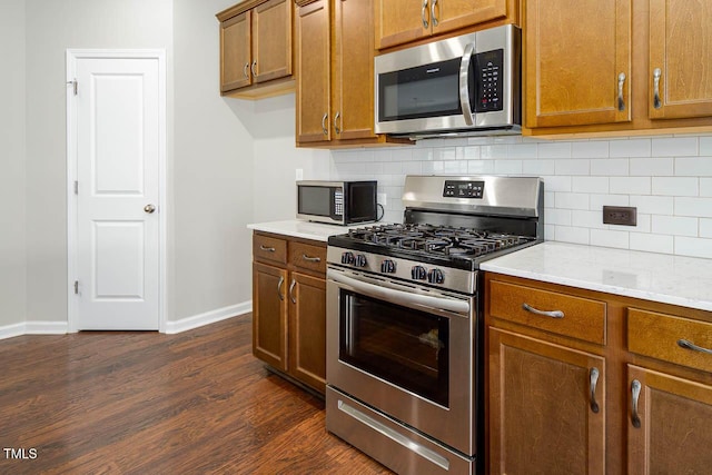 1018 Excite Ave, Morrisville, NC 27560 - kitchen with stainless steel appliances, brown cabinetry, dark wood-style floors, and backsplash