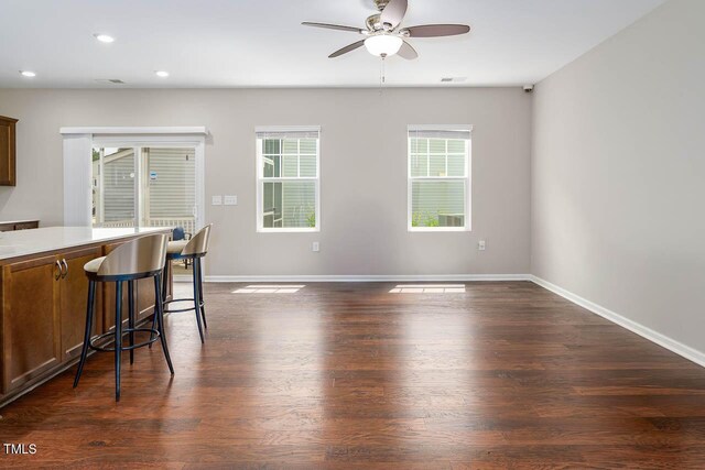 1018 Excite Ave, Morrisville, NC 27560 - kitchen featuring ceiling fan, dark wood-style flooring, a breakfast bar area, recessed lighting, and light countertops