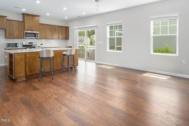 1018 Excite Ave, Morrisville, NC 27560 - kitchen featuring appliances with stainless steel finishes, light countertops, tasteful backsplash, dark wood finished floors, and recessed lighting