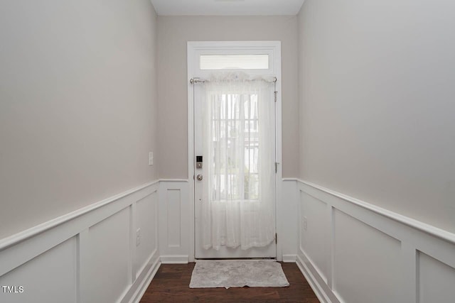 1018 Excite Ave, Morrisville, NC 27560 - doorway to outside featuring wainscoting, healthy amount of natural light, dark wood-type flooring, and a decorative wall