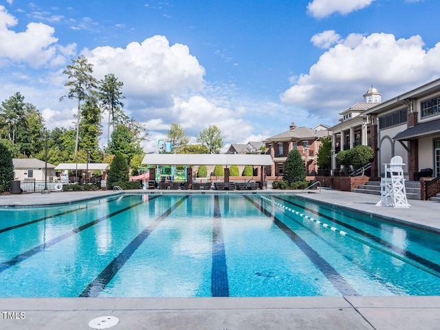 community pool featuring fence and a patio area