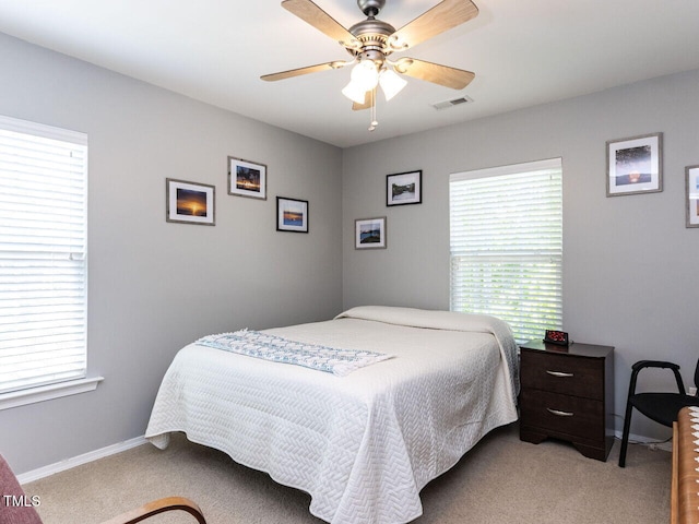 bedroom with visible vents, carpet flooring, baseboards, and ceiling fan