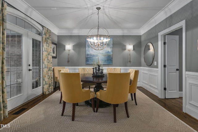 dining area featuring crown molding, a chandelier, and french doors
