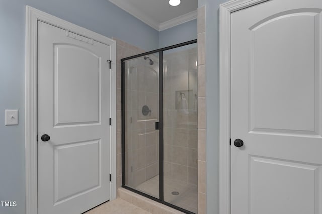 full bath with tile patterned floors, ornamental molding, and a stall shower