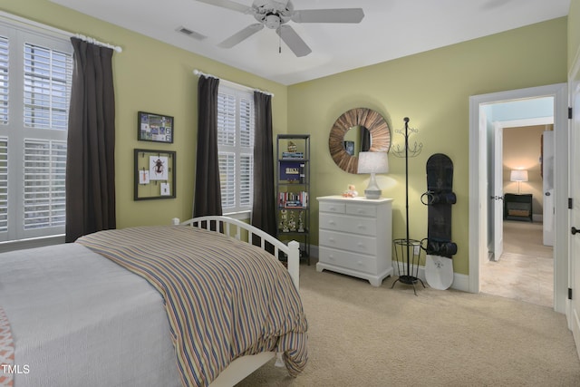 bedroom with carpet flooring, a ceiling fan, baseboards, and visible vents
