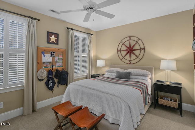 bedroom featuring carpet floors, baseboards, visible vents, and ceiling fan