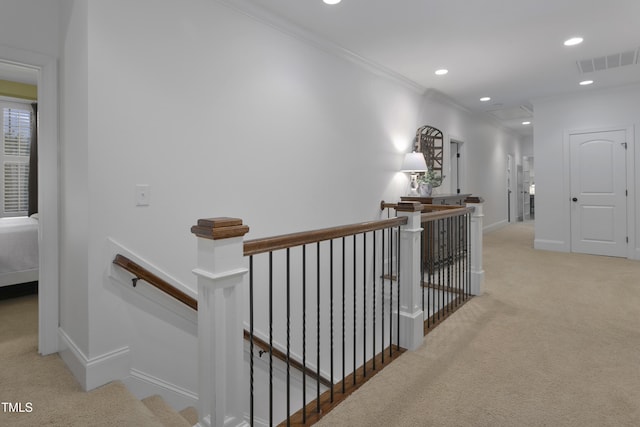 hall featuring visible vents, carpet flooring, and an upstairs landing