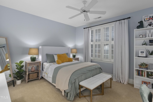 carpeted bedroom featuring a ceiling fan and visible vents