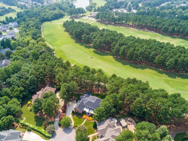 drone / aerial view featuring view of golf course and a residential view