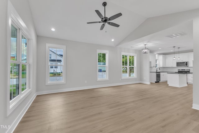 401 N Raiford St, Selma, NC 27576 - unfurnished living room with vaulted ceiling, baseboards, recessed lighting, light wood-style flooring, and ceiling fan