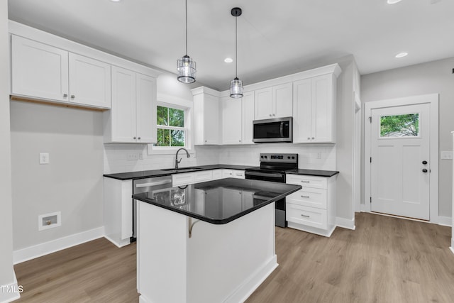 401 N Raiford St, Selma, NC 27576 - kitchen with stainless steel appliances, dark countertops, white cabinetry, a sink, and recessed lighting