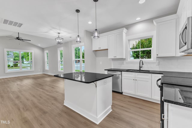 401 N Raiford St, Selma, NC 27576 - kitchen with a sink, stainless steel appliances, light wood finished floors, white cabinets, and recessed lighting