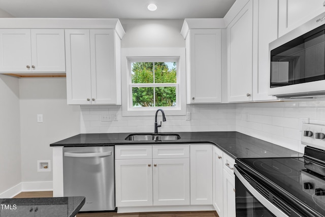 401 N Raiford St, Selma, NC 27576 - kitchen with stainless steel appliances, a sink, decorative backsplash, white cabinets, and recessed lighting