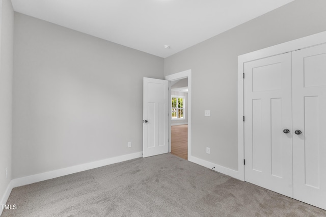 401 N Raiford St, Selma, NC 27576 - unfurnished bedroom with carpet flooring, baseboards, and a closet