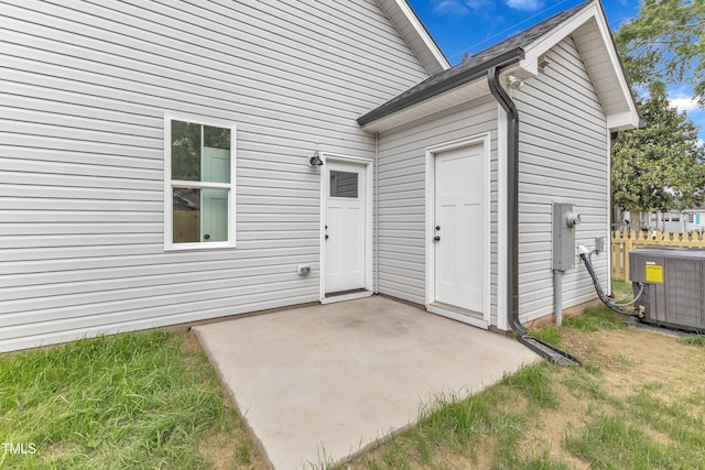 401 N Raiford St, Selma, NC 27576 - view of exterior entry featuring central air condition unit and a patio