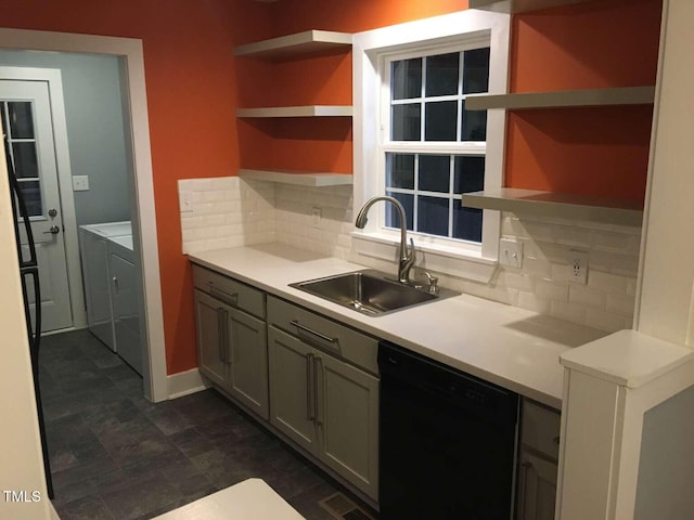 kitchen featuring black dishwasher, washing machine and dryer, a sink, and open shelves
