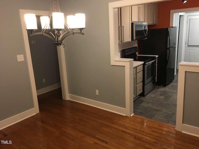 kitchen featuring baseboards, an inviting chandelier, appliances with stainless steel finishes, and light countertops
