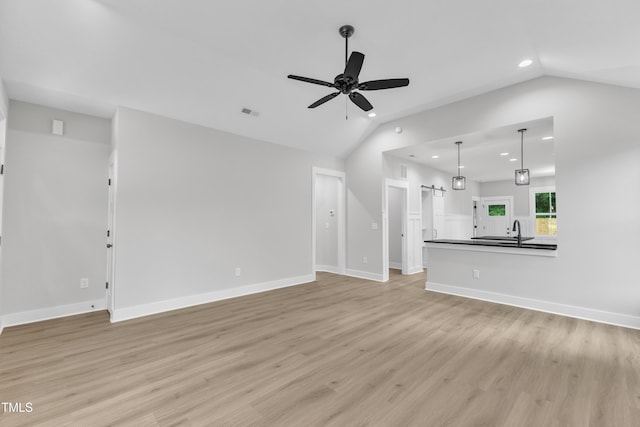 405 N Raiford St, Selma, NC 27576 - unfurnished living room featuring recessed lighting, lofted ceiling, ceiling fan, light wood-type flooring, and a sink
