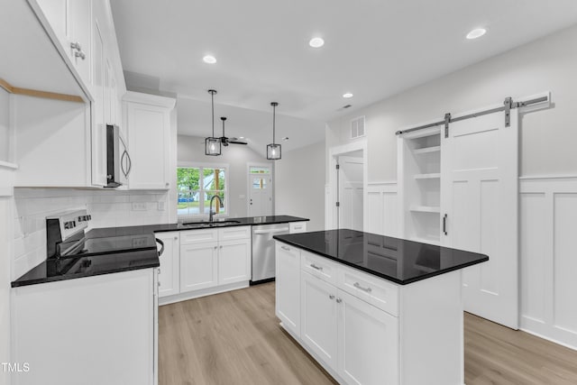405 N Raiford St, Selma, NC 27576 - kitchen with stainless steel appliances, light wood-style flooring, a sink, white cabinets, and recessed lighting