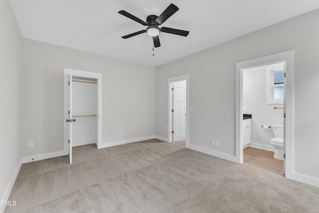 405 N Raiford St, Selma, NC 27576 - unfurnished bedroom with carpet flooring, a spacious closet, baseboards, and connected bathroom